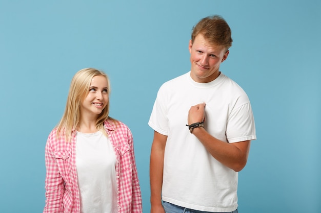 Young fun couple two friends guy girl in white pink empty blank design t-shirts posing 