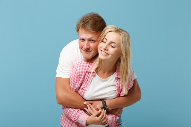 Young fun couple two friends guy girl in white pink empty blank design t-shirts posing 