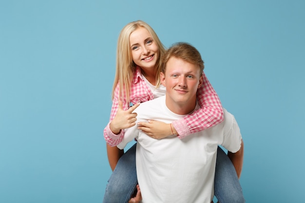 Young fun couple two friends guy girl in white pink empty blank design t-shirts posing 