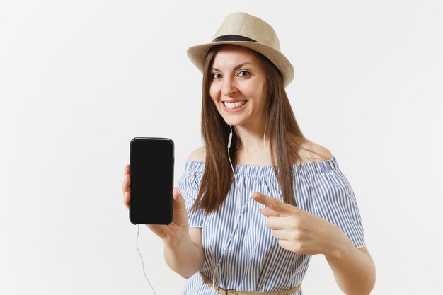 Young fun happy woman listening music in earphones on mobile phone with blank black empty screen isolated on white background. People, sincere emotions, lifestyle concept. Advertising area. Copy space