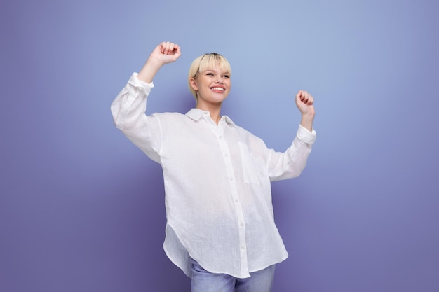 Young funny caucasian blonde secretary woman dressed in a white shirt laughs on the background with