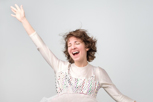 Young funny caucasian woman in costume enjoying the carnival party