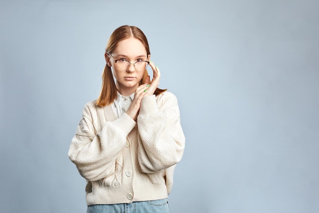 Young funny woman in casual clothes posing isolated over gray background.