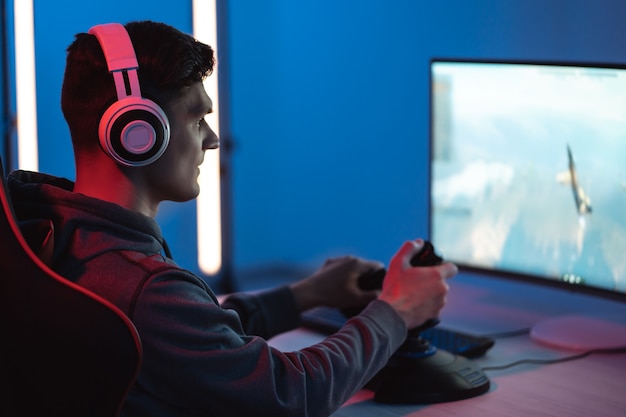 The young gamer playing online video game on his personal computer