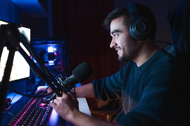 Young gamer playing video games online while broadcasting on social media.