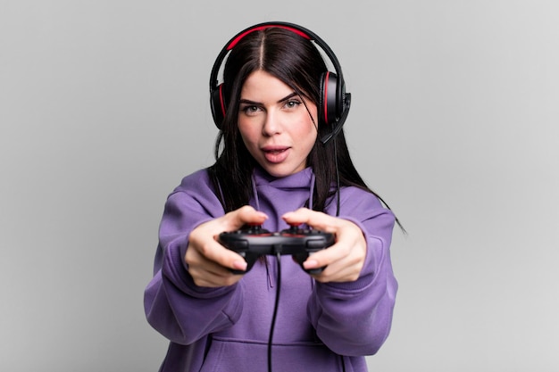 Young gamer woman with a headset and a contoller