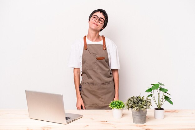 Young gardener woman isolated on white background dreaming of achieving goals and purposes