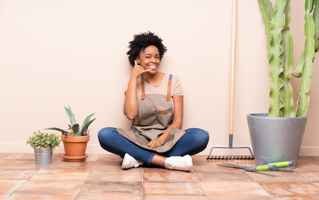 Young gardener woman sitting on the floor