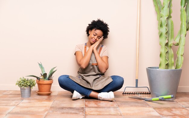 Young gardener woman sitting on the floor