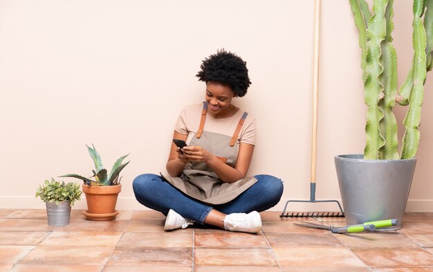 Young gardener woman sitting on the floor