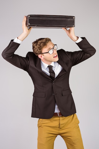 Young geeky businessman holding briefcase