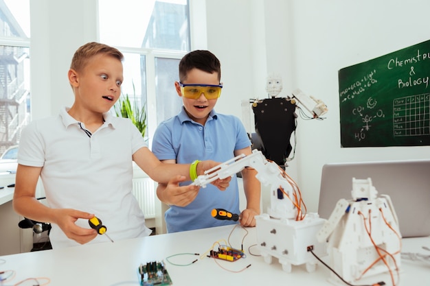 Young genius. Curious intelligent pupils working on a project while having a science class