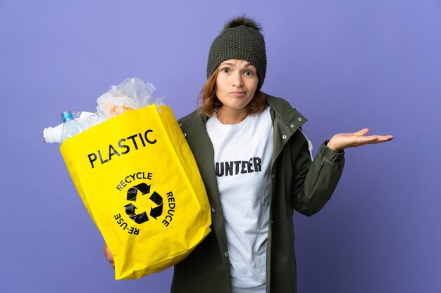 Young Georgian girl holding a bag full of plastic bottles