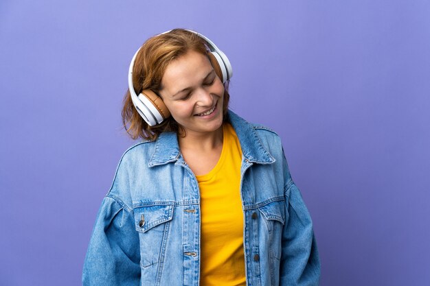 Young Georgian woman isolated listening music