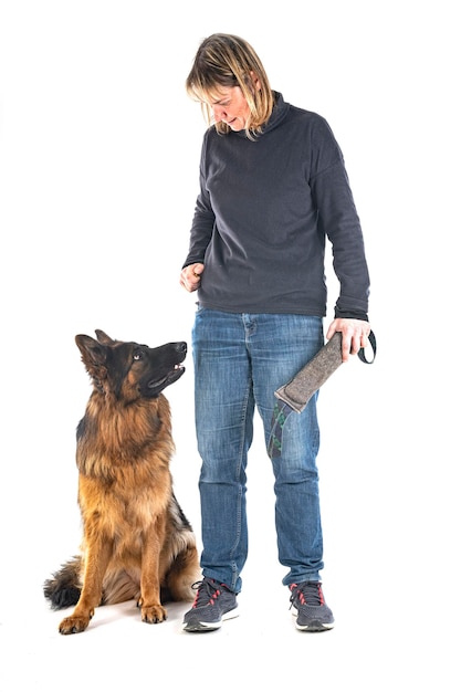Young german shepherd and owner in front of white background