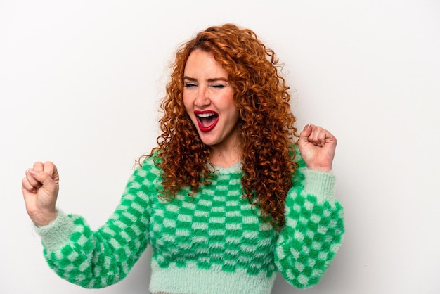 Young ginger caucasian woman isolated on white background dancing and having fun