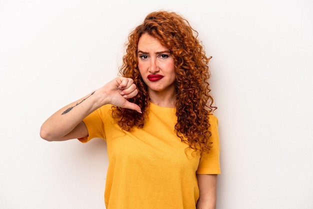 Young ginger caucasian woman isolated on white background showing thumb down disappointment concept