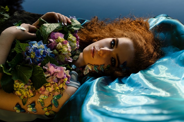 Young ginger girl with butterflies on face