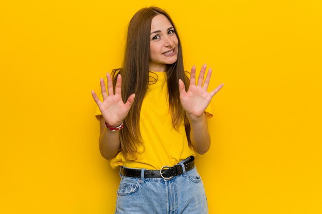 Young ginger redhead woman rejecting someone showing a gesture of disgust.