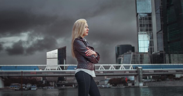 A young girl against a dark sky.