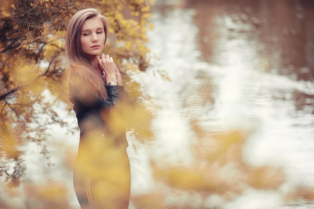 Young girl in autumn in rainy weather