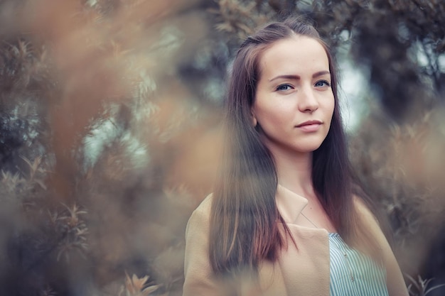 Young girl in autumn in rainy weather