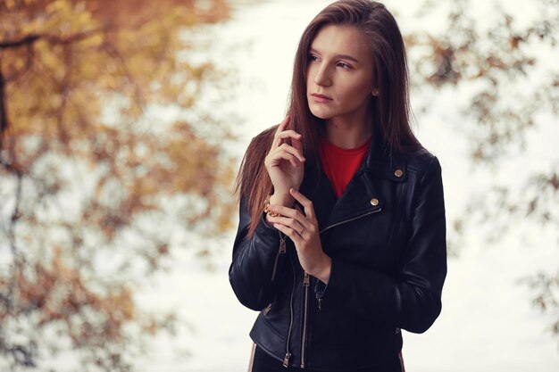 Young girl in autumn in rainy weather