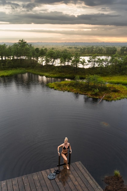 A young girl bathes in a forest lake in the Marimetsa swamp High quality photo