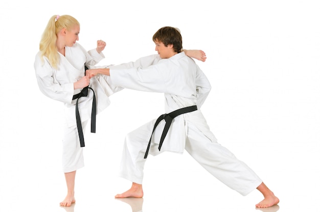 Young girl and boy practicing karate