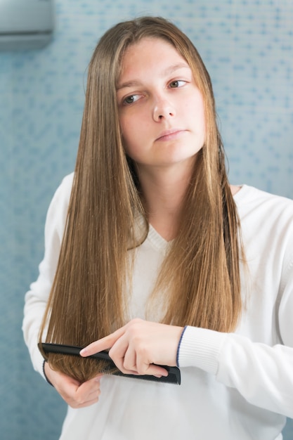 young girl brushing her hair