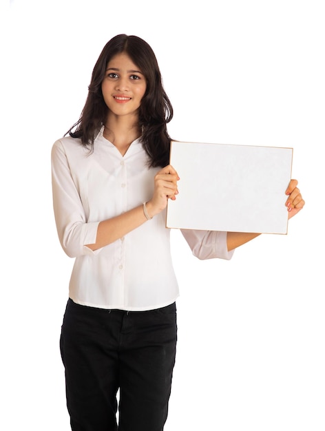 A young girl or businesswoman holding a signboard in her hands on a white background