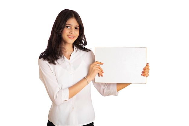 A young girl or businesswoman holding a signboard in her hands on a white background