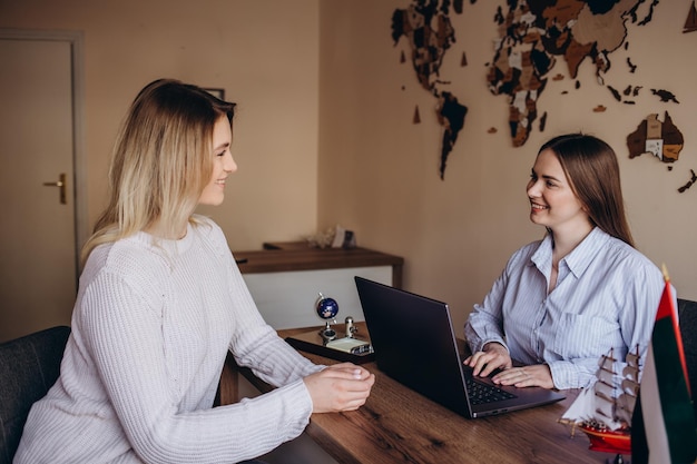 A young girl came to a travel agency She wants to make journey The travel agent helps her