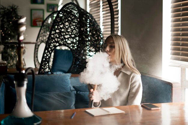 A young girl chilling in the lounge and smoking the hookah