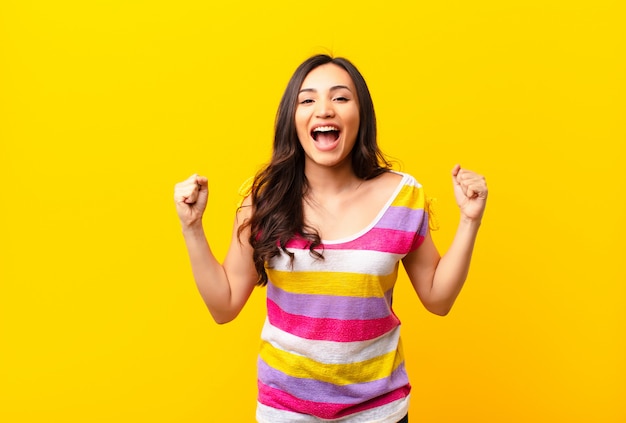 Young girl in colorful t-shirt celebrating victory