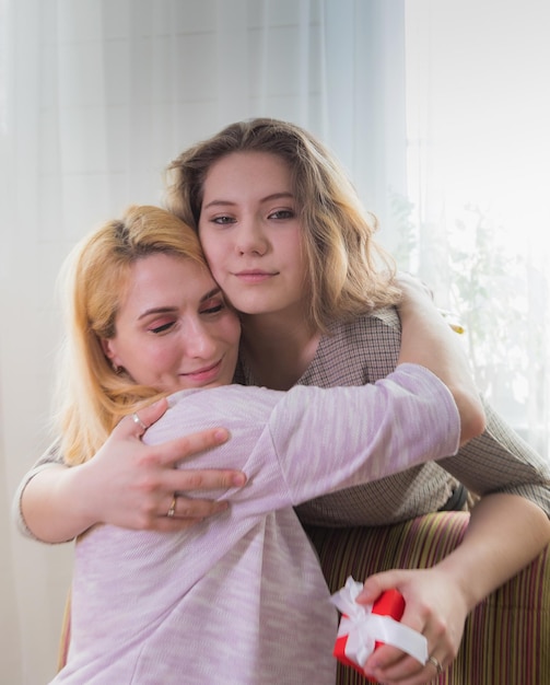 A young girl congratulates her mother on the holiday