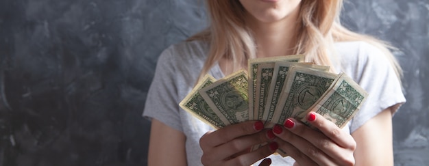 Young girl counting dollar bills