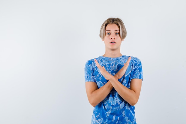 Young girl crossing her arms on white background