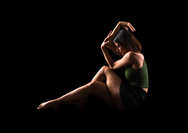 Young girl dancing in studio on isolated background