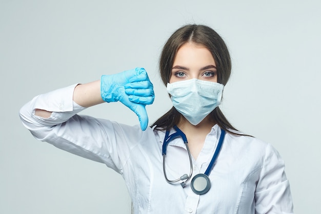 Young girl the doctor holds a thumbs down