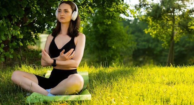 a young girl does yoga in a sports uniform shows elements of sports and asanas