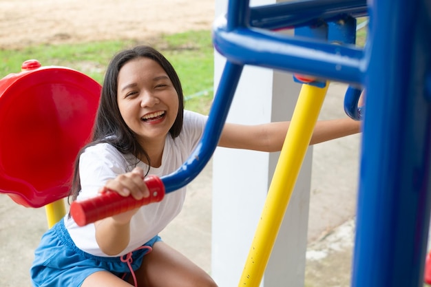 Young girl doing exercise with colorful equipment exercise