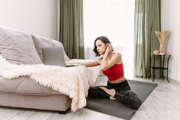 A young girl doing sports at home