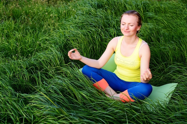 Young girl doing yoga in the backyard