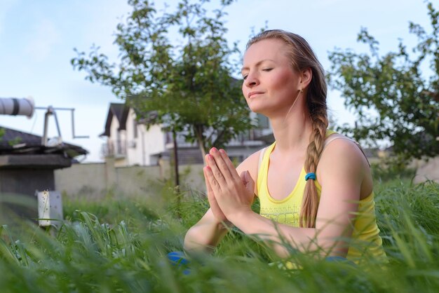 Young girl doing yoga in the backyard