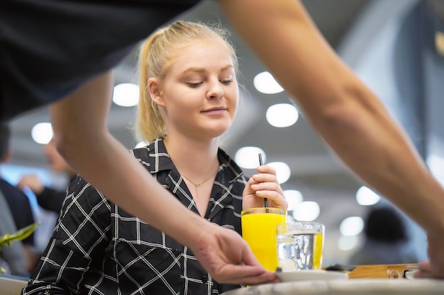 Young girl drinking orange juice