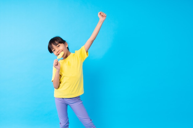 Young girl eating ice cream stick 