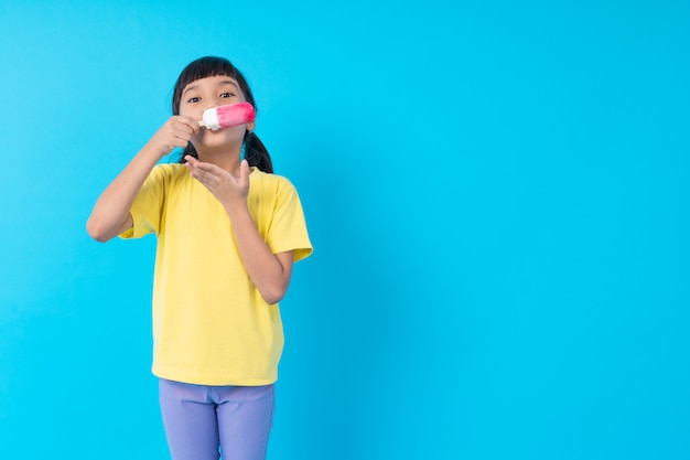 Young girl eating ice cream stick 