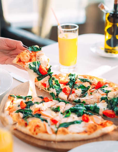 Young Girl eating Pizza in a Restaurant