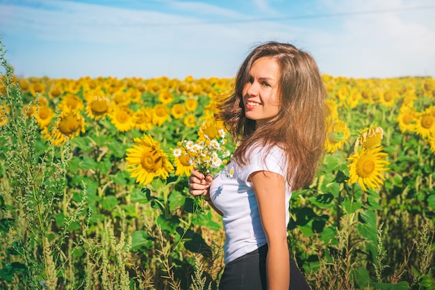 Young girl in a field of sunflowers